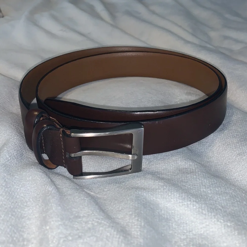 The mens warehouse smooth brown leather belt made in Italy size 38 thin dressy